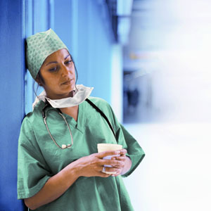 Tired Female Doctor in Scrubs